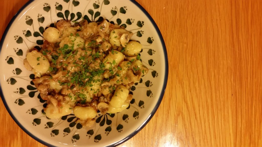 Shows Potato gnocchi with mushrooms and cheese 